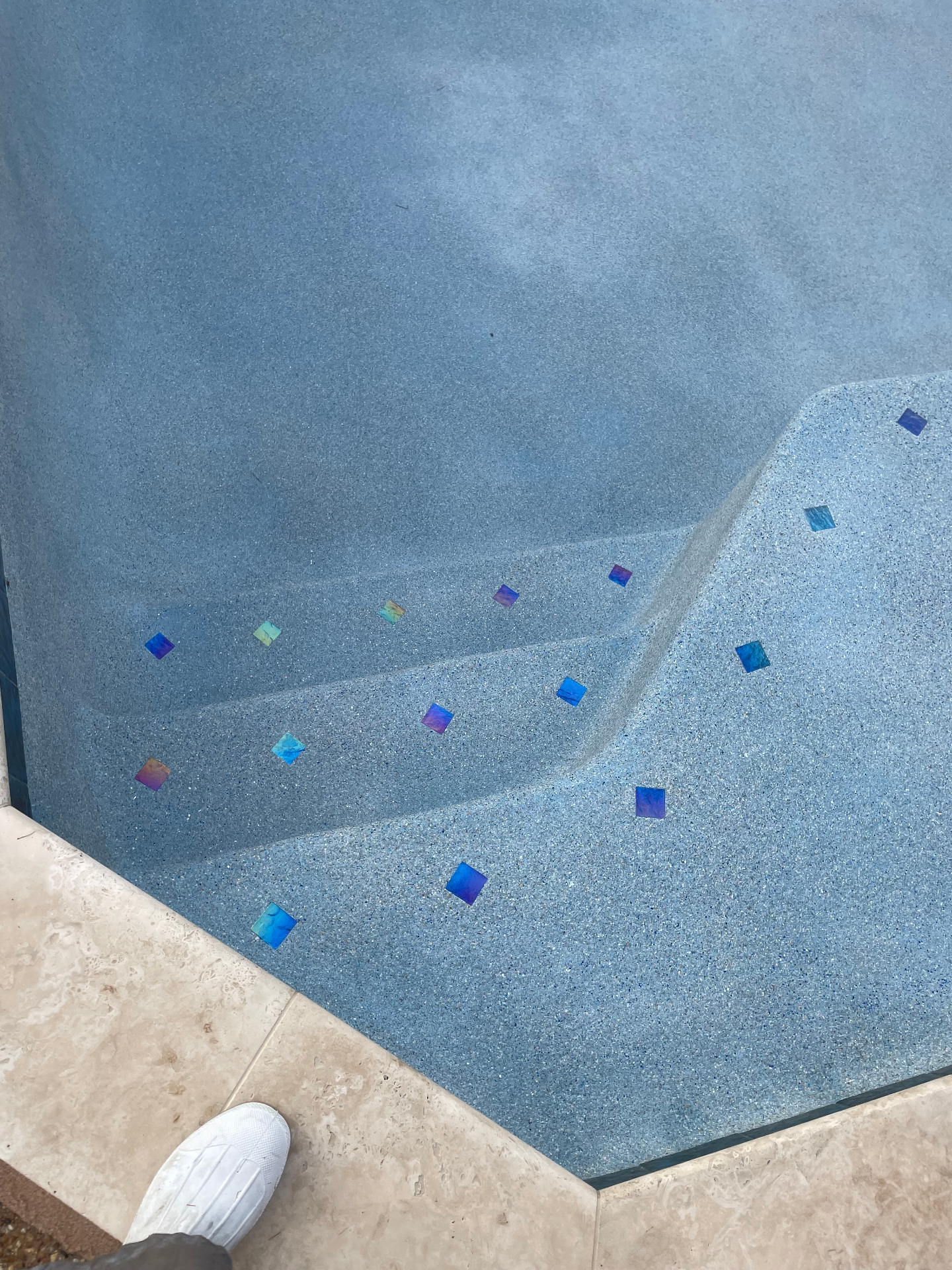 Pebble pool finish with glass tile accents
